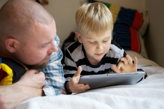 Father and son with a tablet