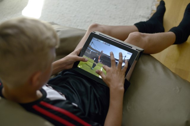 Boy playing football on a tablet