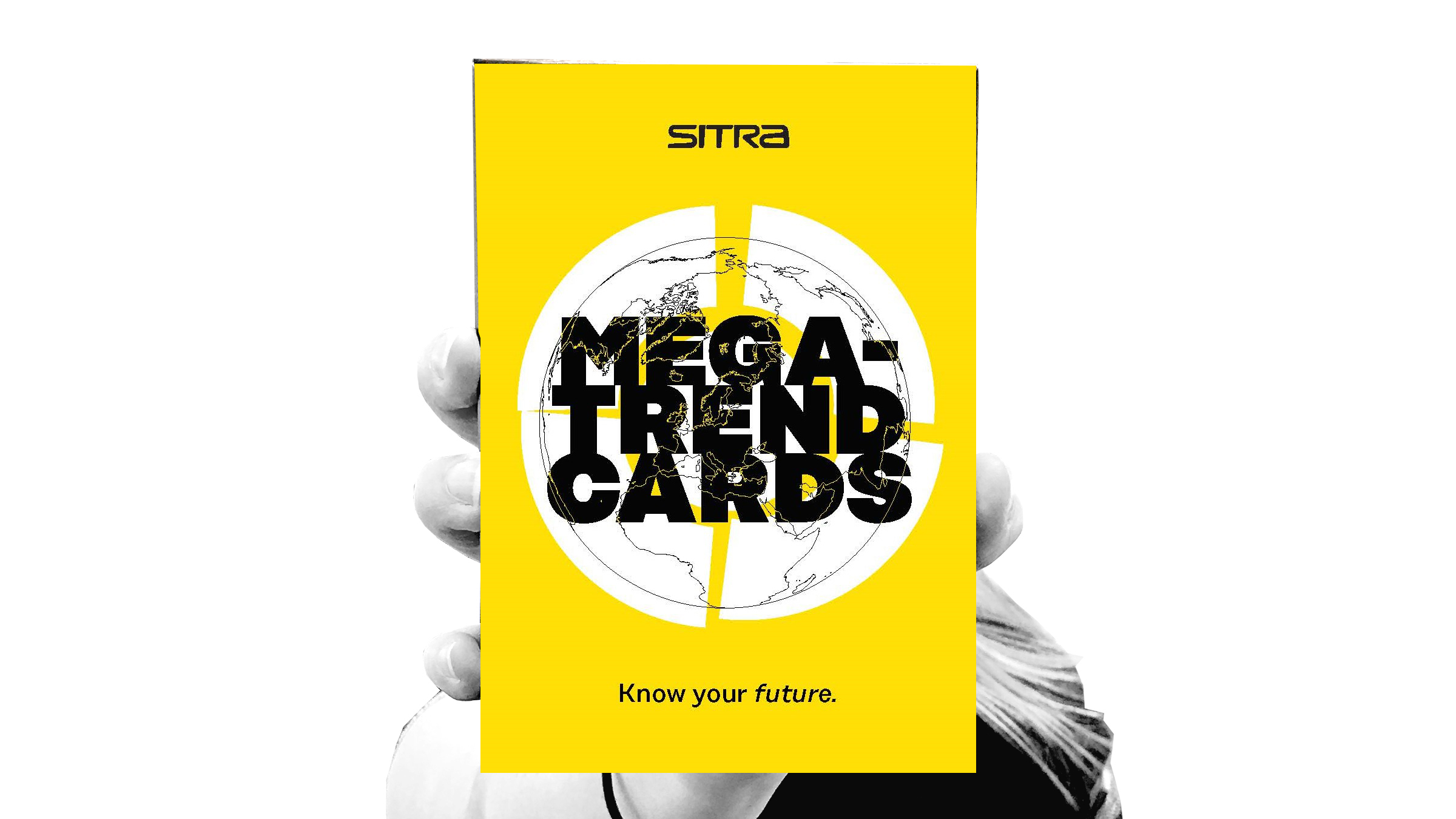 A hand holding megatrend cards