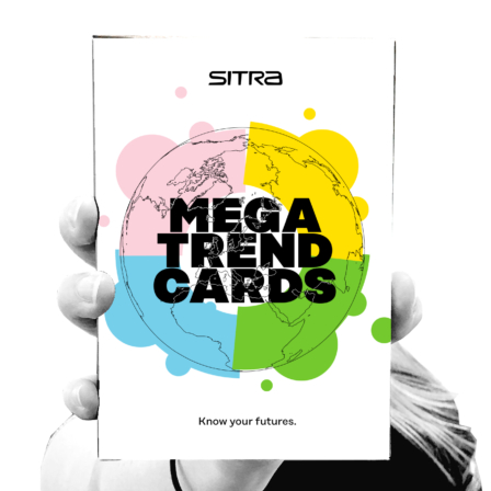 A hand holding megatrend cards