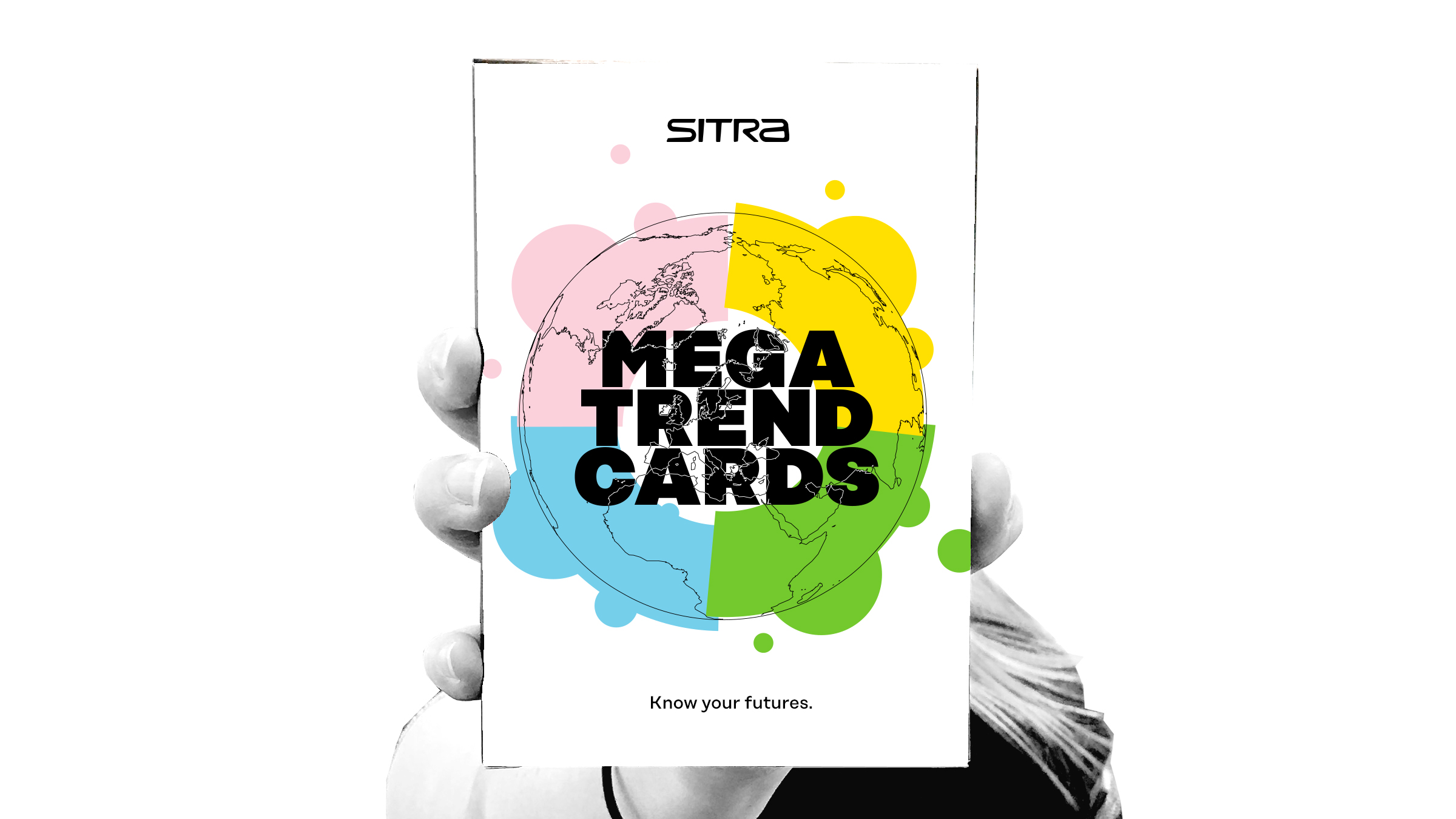 A hand holding megatrend cards