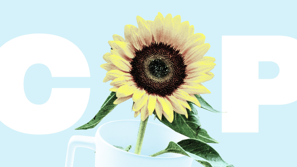 A coffee mug, text COP and a sunflower